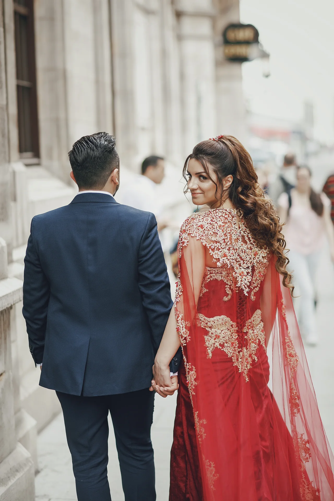 Couple walking hand in hand through the city